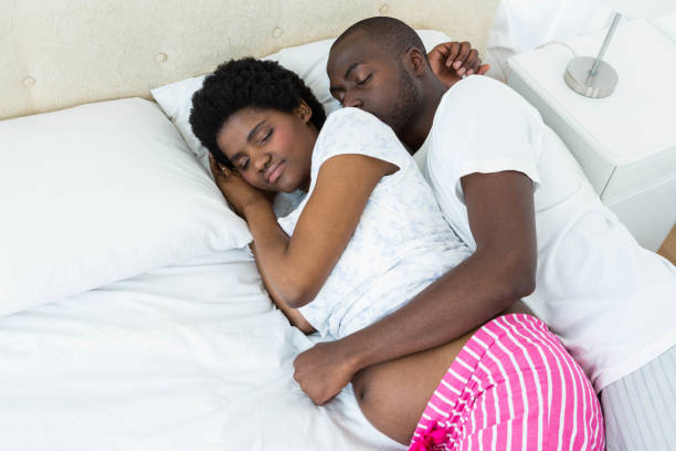 istock Pregnant couple relaxing on bed 845274332