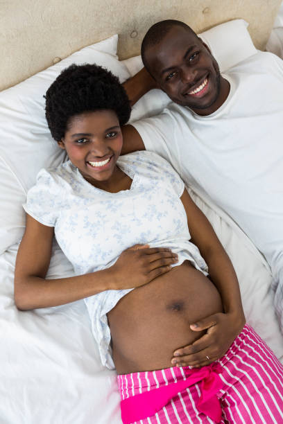 istock Pregnant couple relaxing on bed 845274462