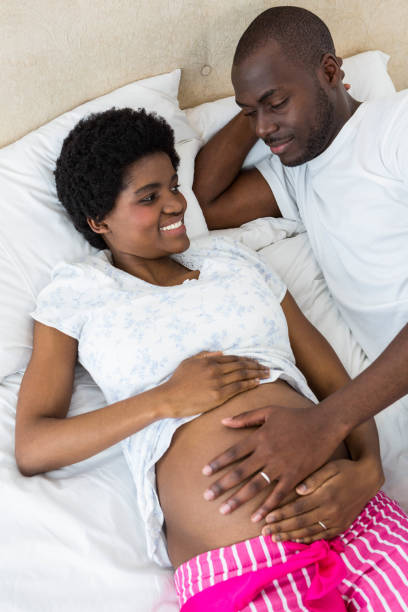 istock Man touching pregnant womans stomach while relaxing on bed 845274470
