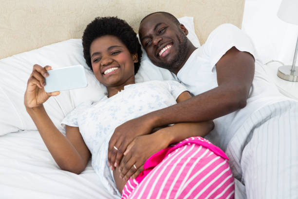 istock Pregnant couple looking at mobile phone 845274524