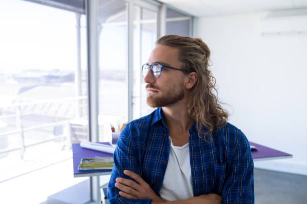 istock Male architect standing with arms crossed in office 845277538