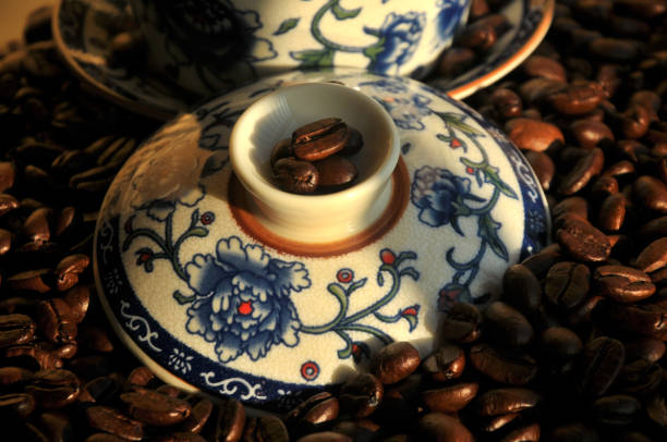 Chinese tea set and  coffee beans in sunset