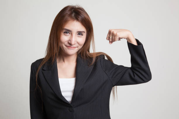 istock Beautiful young Asian woman flex bicep. 845286478