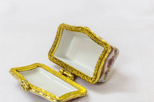 istock Tiny colorful jewel box with gold platted crimp in a white background. Macro with extremely shallow depth of field. Selective focus on the jewel box. 845289662