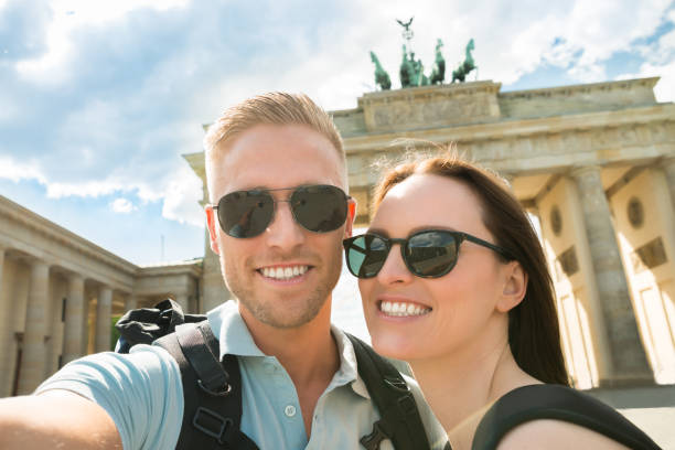 istock Young Couple Taking Selfie In Front Of Brandenburg Gate 845289832