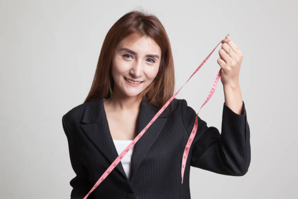 istock Young Asian woman with measuring tape. 845292704
