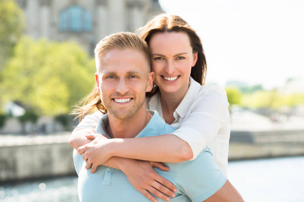 istock Happy Man Carrying Woman On His Back 845292922