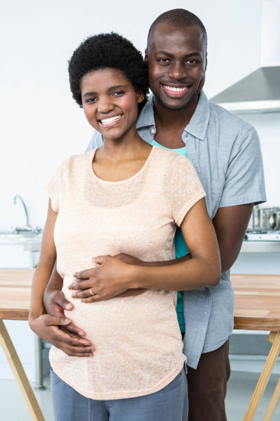 istock Pregnant couple embracing in kitchen 845293054