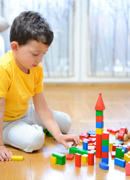 istock A five year old boy playing with wooden cubes. 845293310