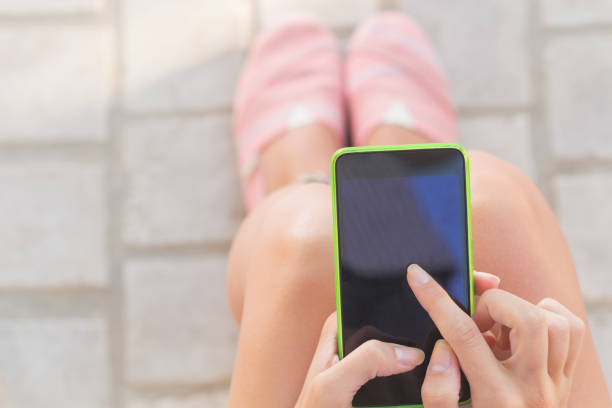 istock Girl texting while sitting on the bench outdoors. 845304416