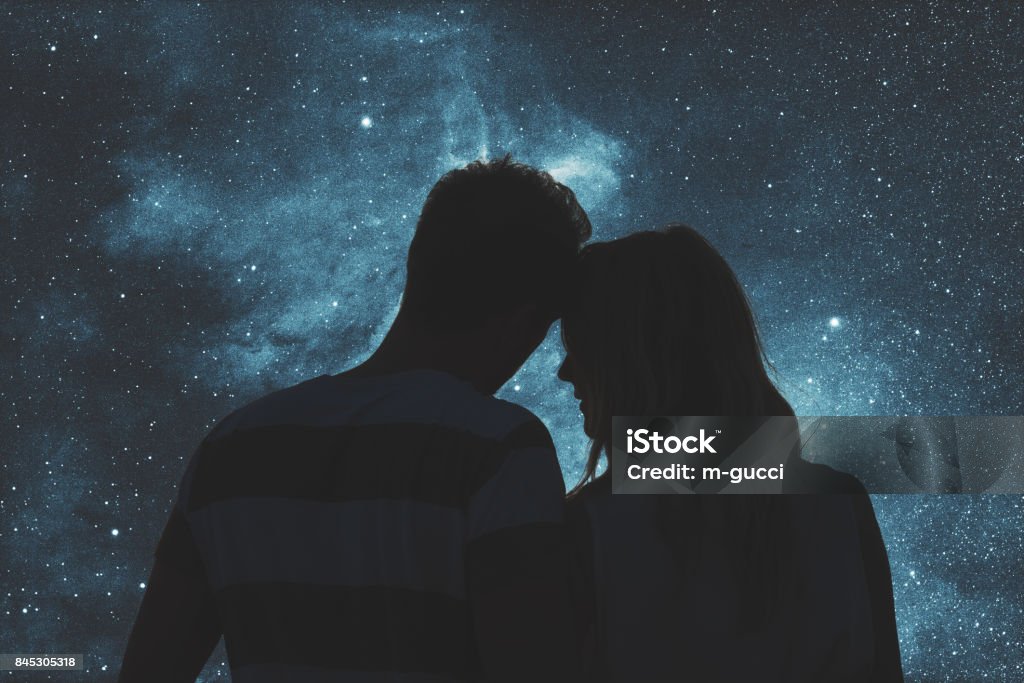 Silhouettes of a young couple under the starry sky. My astronomy work. Couple - Relationship Stock Photo
