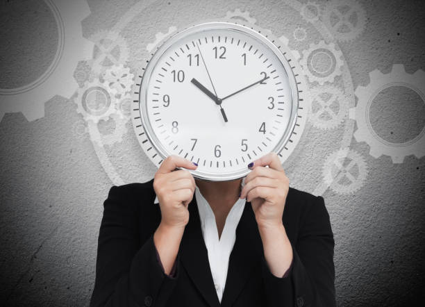 istock Businesswoman hiding her face with clock 845307662
