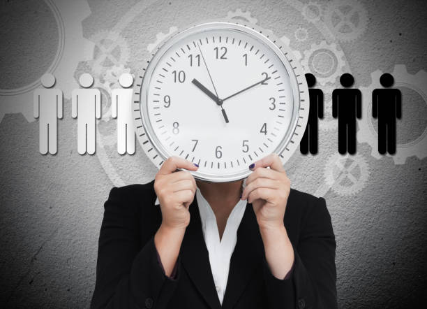 istock Businesswoman hiding her face with wall clock 845307688