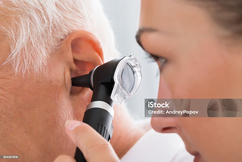 Female Doctor Examining Patient's Ear Close-up Of Female Doctor Examining Patient's Ear With Otoscope Ear Stock Photo