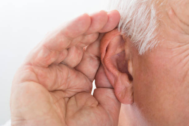 Close-up Of A Senior Man Trying To Hear Hand Over Ear