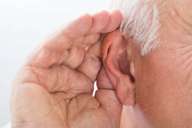 Close-up Of A Man Trying To Hear Close-up Of A Senior Man Trying To Hear Hand Over Ear hearing loss photos stock pictures, royalty-free photos & images