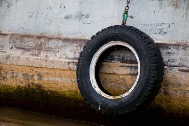 Aswan, Egypt - July 21, 2016: An old painted tire on a ferry, used as a bumper to protect the hull during docking.