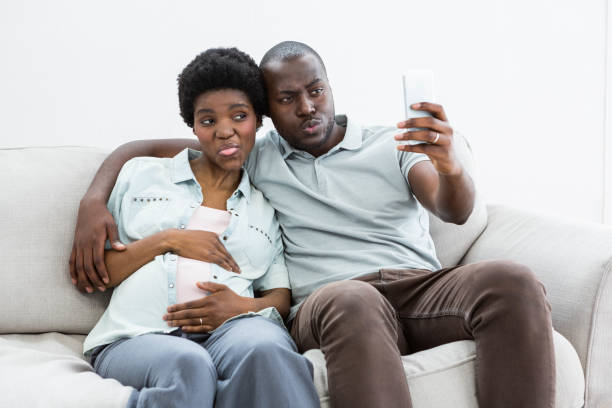 istock Pregnant couple taking a selfie on mobile phone 845317054
