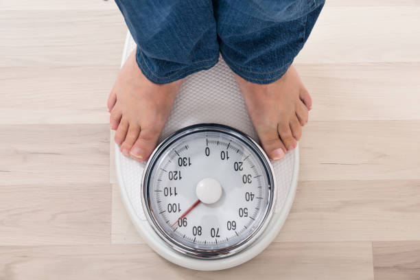 istock Person Standing On Weighing Scale 845319636