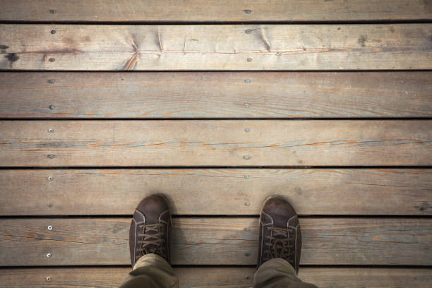 Leather boots on wooden floor background