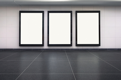 Three blank posters on a station wall. Includes clipping path.