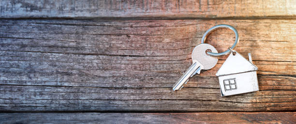 House Key And Keychain On Wooden Table House Keychain On Old Table house key photos stock pictures, royalty-free photos & images