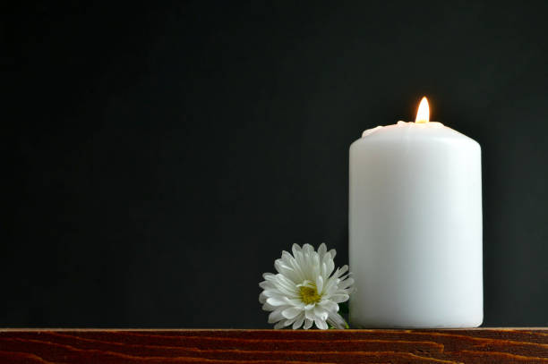 istock Burning candle and white flower 845345304