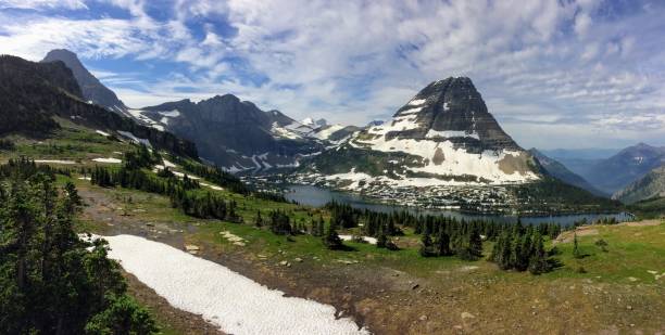 Going to the Sun Road, View of Landscape, snow fields In Glacier National Park around Logan Pass, Hidden Lake, Highline Trail, which features waterfalls, wildlife, and is surrounded by mountains including: Piegan, Pollock, Oberlin, Clements, Reynolds and Heavy Runner Mountain Montana USA va a la carretera del sol, vista del paisaje, campos de nieve en parque nacional los glaciares alrededor de logan pass, lago escondido, camino de highline, que cuenta con cascadas, flora y fauna y está rodeado por montañas como: pollock, oberlin, piegan, clements, reynolds