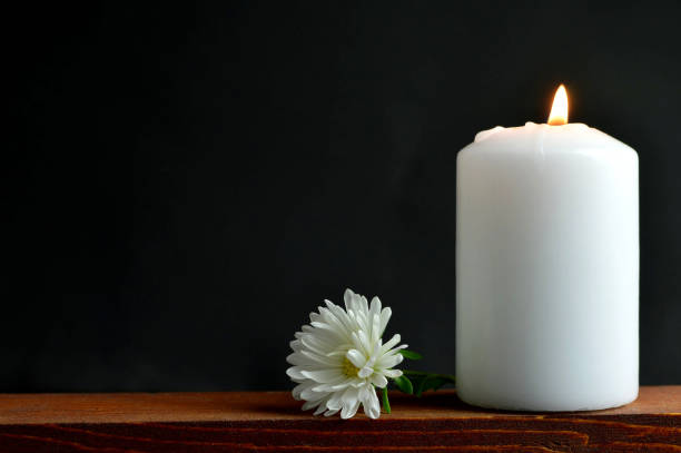 istock Burning candle and flower on dark background 845348558