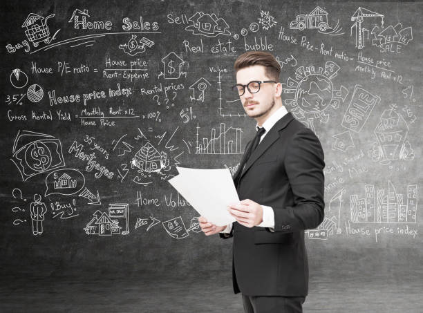 istock Serious businessman with documents, home sales 845350844