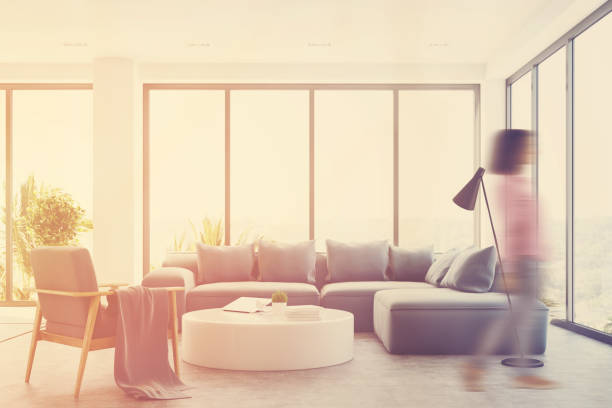 istock White living room interior with a blue sofa, girl 845351316