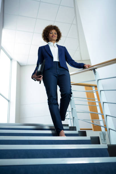istock Businesswoman with diary climbing down the stairs 845354076