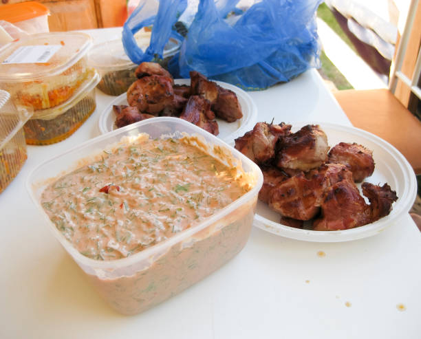 istock Shish kebab in disposable dishes. Fried meat in plastic plates. 845358420