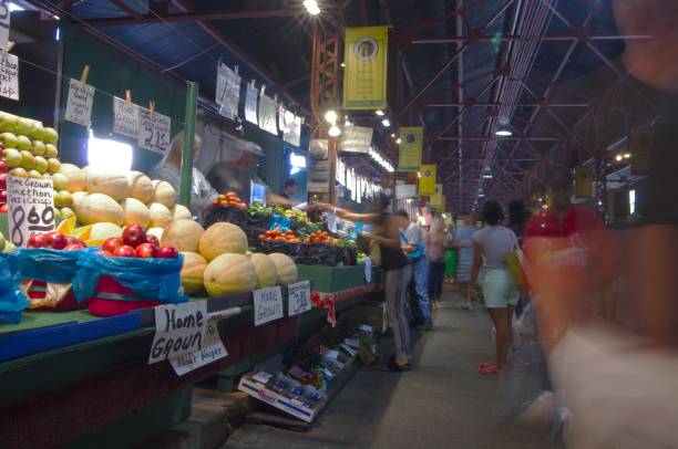 Long time exposure allows farmers market stalls to remain in focus as crowds fade away Saint Louis, Missouri--September 9, 2017, shoppers purchase produce and household items at the Soulard Market in the historic St. Louis, MO French Quarter.  Photo By Phil Rozenski, of Shiloh Illinois fade in stock pictures, royalty-free photos & images