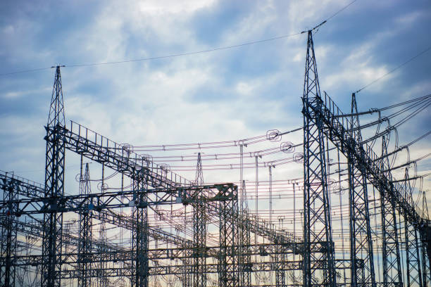 Evening landscape of power transmission facility. Silhouette of steel tower and electric wire.