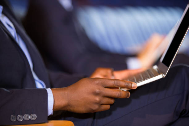 istock Mid section of male business executive using laptop 845373292