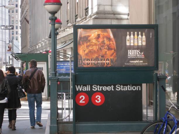 People passing by outside the entrance to the Wall Street Subway Station in Downtown Manhattan, New York City, April 2010