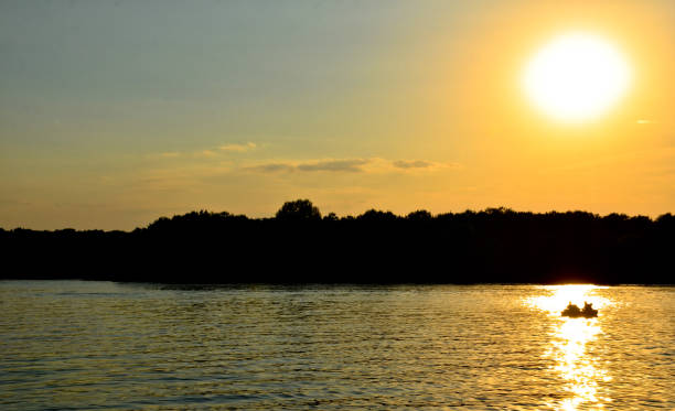 istock river summer sunset yellow sun beam boat on the river 845393228