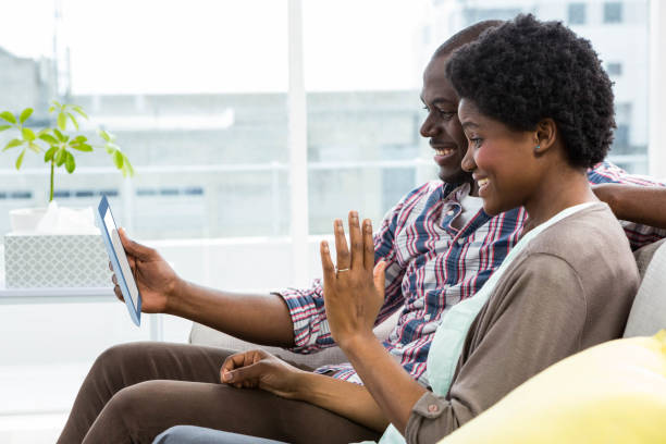 istock Pregnant couple looking at digital tablet 845394058