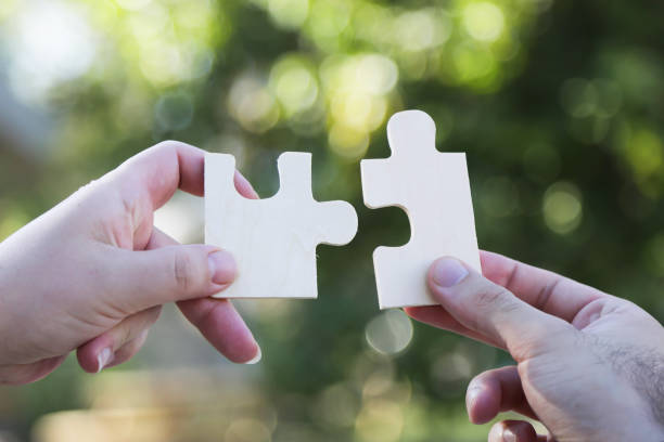 istock business people assembling jigsaw puzzle and represent team support and help concept. Building a business success. Concept for consulting, marketing, business, strategy and planning. 845396202
