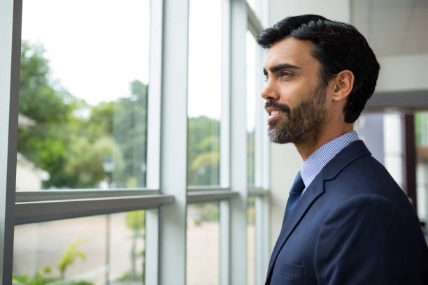 istock Businessman looking through the window 845396722