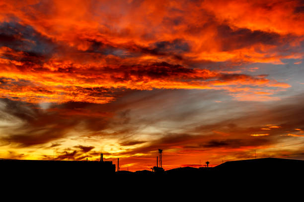 sunrise with vivid colorful sky, clouds and dark silhouettes.