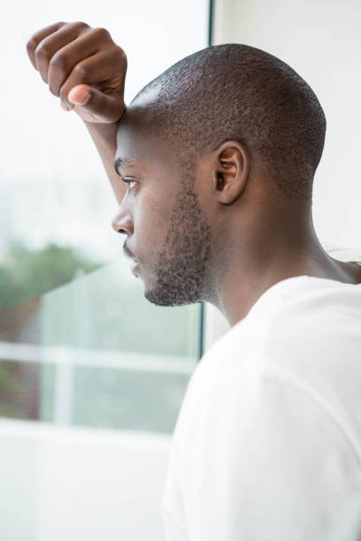 istock Thoughtful man looking out of window 845402720