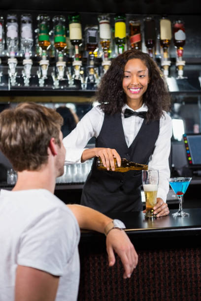istock Beautiful barmaid pouring beer in glass 845416468