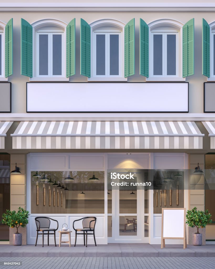 The front of the street shop 3d rendering image The front of the street shop 3d rendering image.There are a street shop, the building has classic style and pastel color scheme. The front store has footpaths and table sets. Store Stock Photo