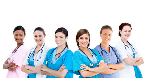 istock Smiling female hospital workers standing arms folded in line 845429786