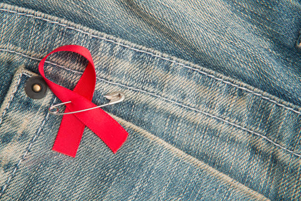 istock Aids awareness ribbon pinned on to jeans 845432476