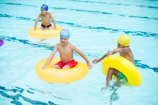 istock Shirtless boys swimming in pool 845435592