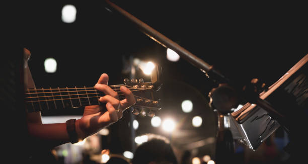 istock Guitarist on stage. Guitarist playing guitar, soft and blur concept. 845447068