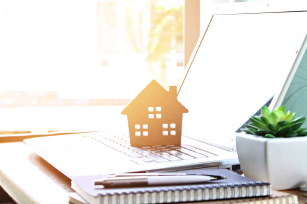 Wood house model on computer laptop Business, finance, savings, property ladder or mortgage loan concept : Wood house model on computer laptop wealthy house stock pictures, royalty-free photos & images
